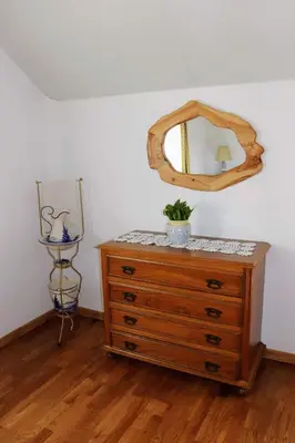a dresser with a mirror on top of it at Quinta Terezinha in Ribeira Brava