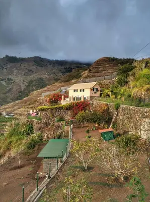 a house on top of a hill with a house at Quinta Terezinha in Ribeira Brava