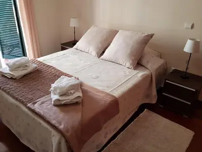 a bedroom with a bed with two towels on it at Vila Régia in Funchal
