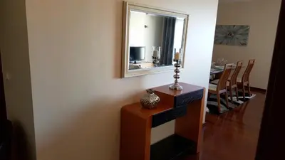 a room with a mirror and a table and chairs at Vila Régia in Funchal