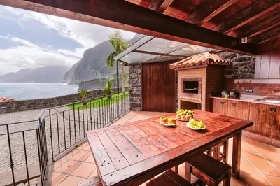 a balcony of a house with a view of the ocean at Seixal Sunny Villa A & B by Amazing Madeira in Seixal