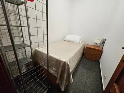 a small bedroom with a bed and a night stand at Apartment Bonimar in Funchal