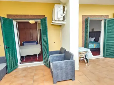a room with green doors and a bedroom with a bed at Apartment Bonimar in Funchal