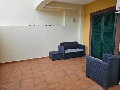 a living room with a couch and a chair at Apartment Bonimar in Funchal