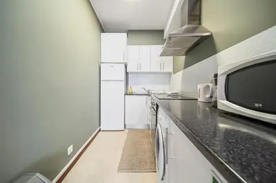 a kitchen with a counter top with a microwave at Funchal Paradise in Funchal