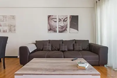 a living room with a couch and a table at Rodamar I by An Island Apart in Funchal
