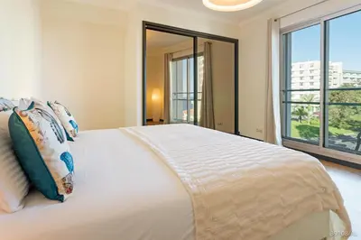 a bedroom with a large bed with a large window at Rodamar I by An Island Apart in Funchal