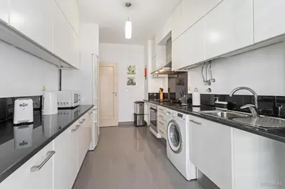 a white kitchen with a sink and a dishwasher at Rodamar I by An Island Apart in Funchal