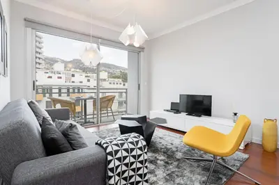 a living room with a couch and a tv at Santa Catarina l by An Island Apart in Funchal