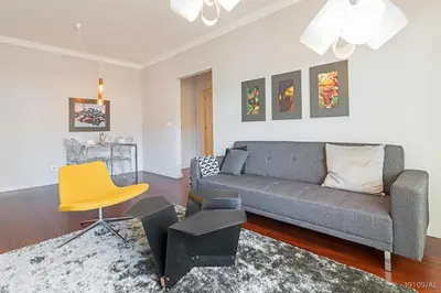 a living room with a couch and a yellow chair at Santa Catarina l by An Island Apart in Funchal