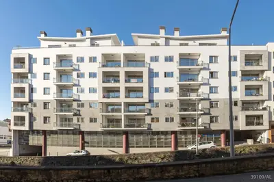 an apartment building with cars parked in front of it at Santa Catarina l by An Island Apart in Funchal