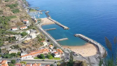 an aerial view of a beach with a roller coaster at Estrela do Mar - Alojamento Local in Calheta