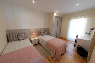 a bedroom with two beds and a window at Estrela do Mar - Alojamento Local in Calheta