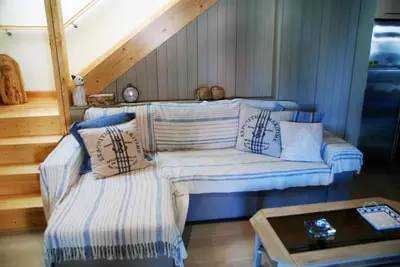 a living room with a couch and a table at Estrela do Mar - Alojamento Local in Calheta