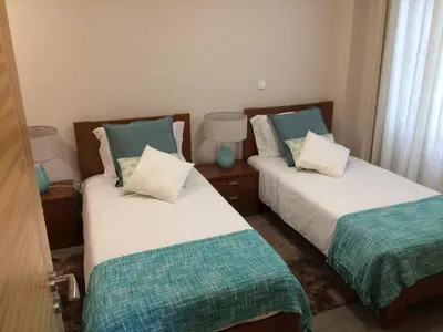 two beds in a small room with two pillows at Apartamentos Sousa in Funchal