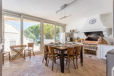 a dining room with a table and chairs in a kitchen at Top Cliff Villa with Ocean View and Private Pool UP to 18 Guests in Burgau
