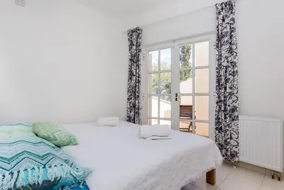 a white bedroom with a bed and a window at Top Cliff Villa with Ocean View and Private Pool UP to 18 Guests in Burgau