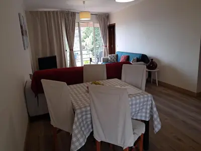 a living room with a table and a couch at Apartamento Vai Vem in Madalena do Mar