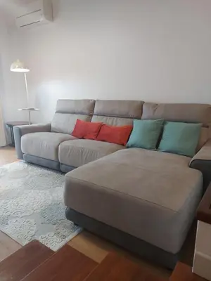 a couch with four pillows on it in a living room at Bay View Apartment in Funchal