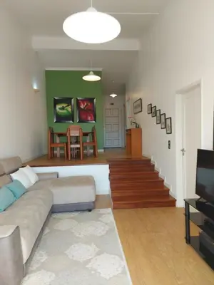 a living room with a couch and a television at Bay View Apartment in Funchal