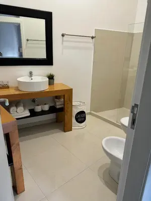 a bathroom with a sink and a toilet and a mirror at The Loft Junction in Funchal