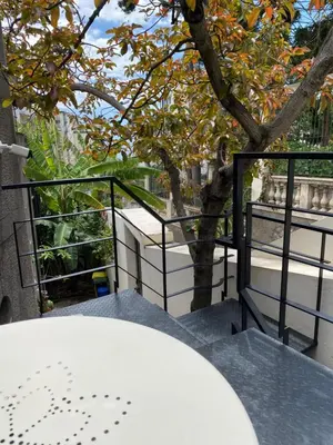 a balcony with a table and a tree at The Loft Junction in Funchal