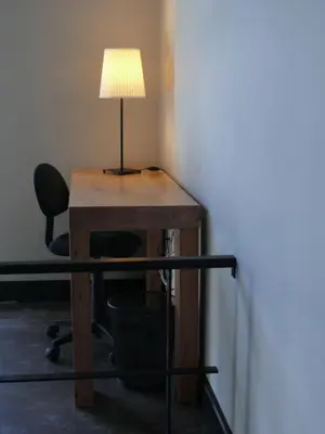 a desk with a lamp and a chair at The Loft Junction in Funchal