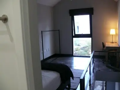 a small bedroom with a bed and a window at The Loft Junction in Funchal