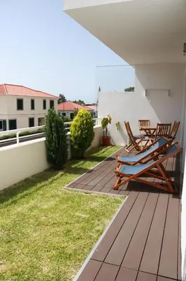 a deck with two chairs and a table on a house at Mericia's Gorgeous View in Funchal