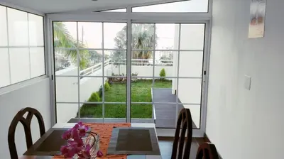 a dining room with a table and a large window at Mericia's Gorgeous View in Funchal