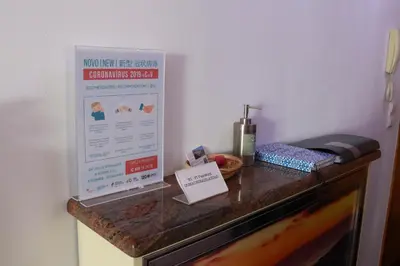 a sign on top of a counter with a phone at Mericia's Gorgeous View in Funchal