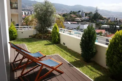 a balcony with two chairs and a view of the city at Mericia's Gorgeous View in Funchal