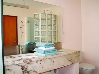 a bathroom with a sink with towels on it at Great view to sea, villa with pool in Salema