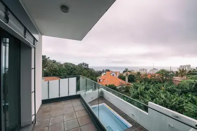a balcony with a swimming pool on top of a building at Casa Branca in Funchal