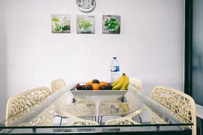a table with chairs and a bowl of fruit on it at Casa Branca in Funchal