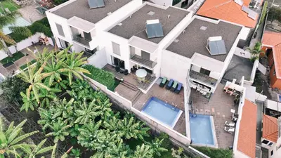 an aerial view of a house with two swimming pools at Casa Branca in Funchal