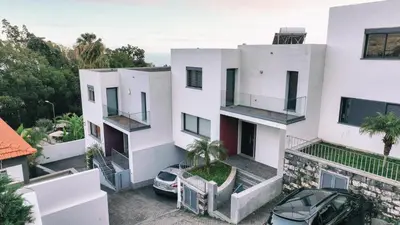 an apartment building with a car parked in front of it at Casa Branca in Funchal