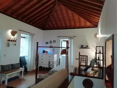 a living room with a couch and a table at Casa do Norte - Santa Maria in Norte