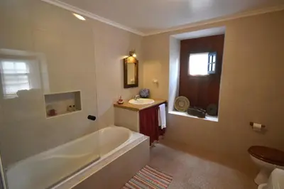 a bathroom with a tub and a sink at Casa do Norte - Santa Maria in Norte