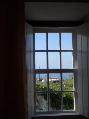 a window with a view of a field of plants at Casa do Norte - Santa Maria in Norte