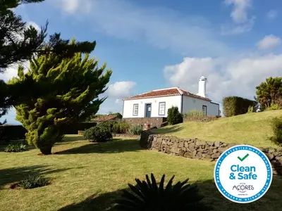 a house on a hill with a sign for a clean and sale at Casa do Norte - Santa Maria in Norte