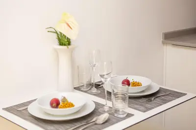 a table with plates of food and wine glasses at The Marketplace by Storytellers in Funchal