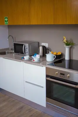 a kitchen with a sink and a stove top oven at The Marketplace by Storytellers in Funchal