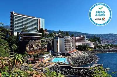 a view of a resort with a pool and buildings at Pestana Madeira Beach Club in Funchal