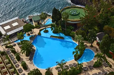 an overhead view of a resort with a large swimming pool at Pestana Madeira Beach Club in Funchal