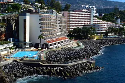 an aerial view of a hotel and the water at Pestana Madeira Beach Club in Funchal