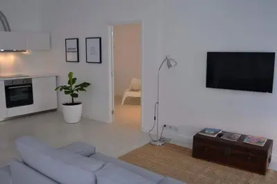 a living room with a couch and a flat screen tv at Charming Apartment 101 in Funchal