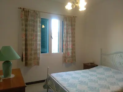 a bedroom with a bed and a window at Casa Mansa in Porto Santo