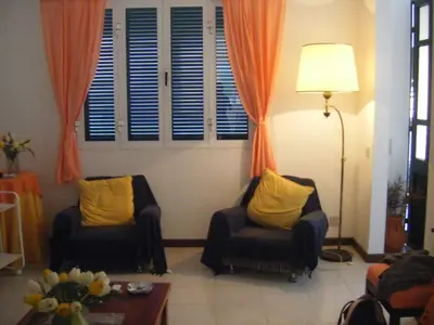 a living room with two chairs and a lamp at Casa Mansa in Porto Santo