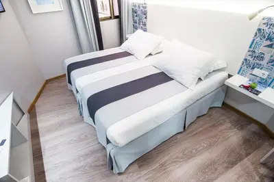 a small bedroom with a bed and a window at Sé Boutique Hotel in Funchal